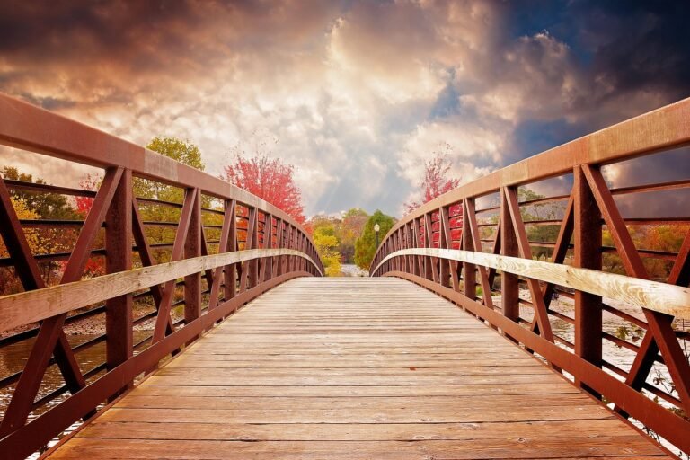 Wooden bridge leading from dark clouds into light, symbolizing pathways to recovery from trauma.