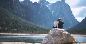 A couple at a lake, closely together, symbolizing closeness due to understanding boundary myths.