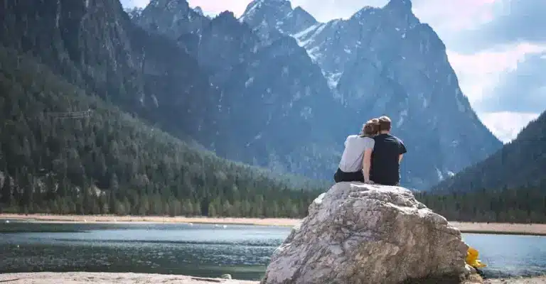 A couple at a lake, closely together, symbolizing closeness due to understanding boundary myths.
