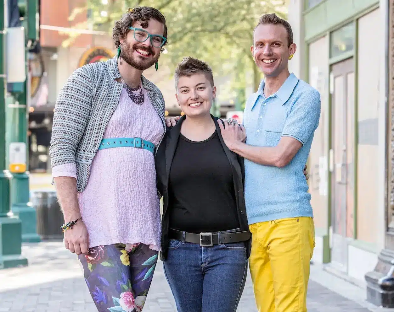 The image shows three gender diverse people, practicing anti-oppressive practice.