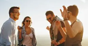 The image shows four happy people on their journey of trauma recovery