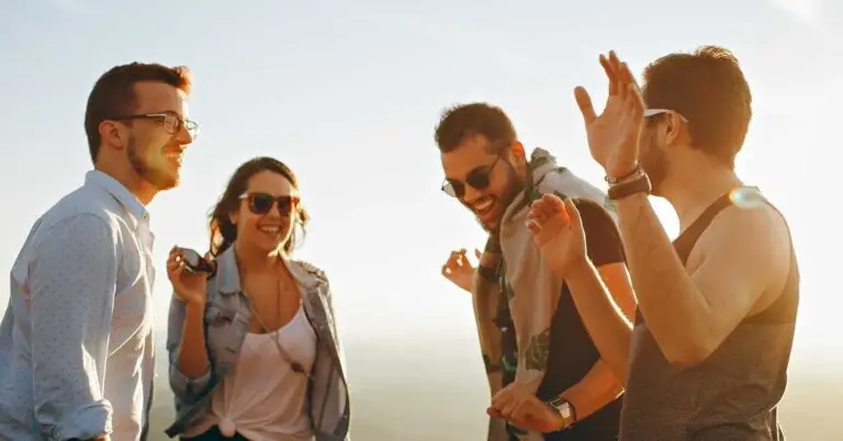 The image shows four happy people on their journey of trauma recovery