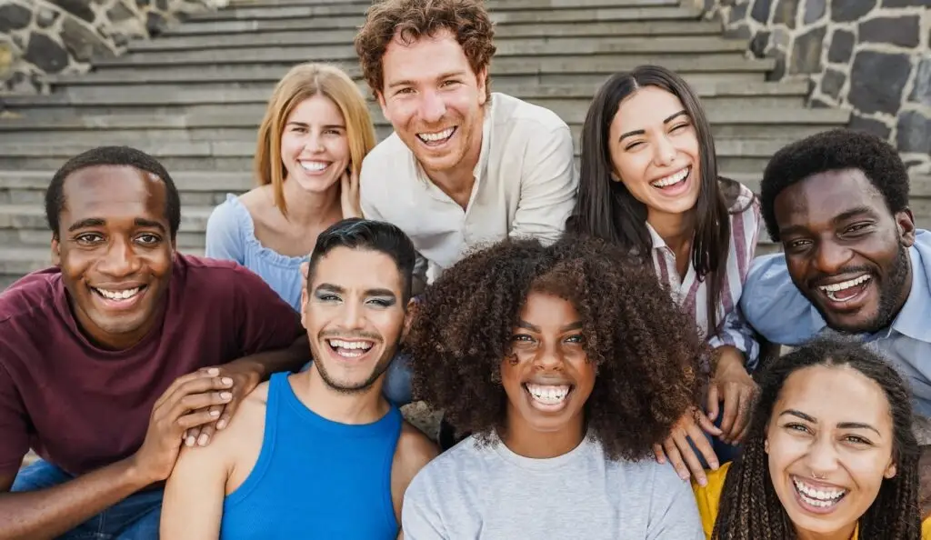 Diverse people sharing a joyful moment together, symbolizing anti-oppressive practice and inclusion.