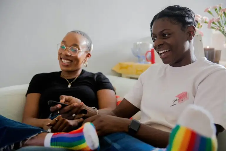 The image shows two queer people playing together after successful EMDR therapy for PTSD treatment.