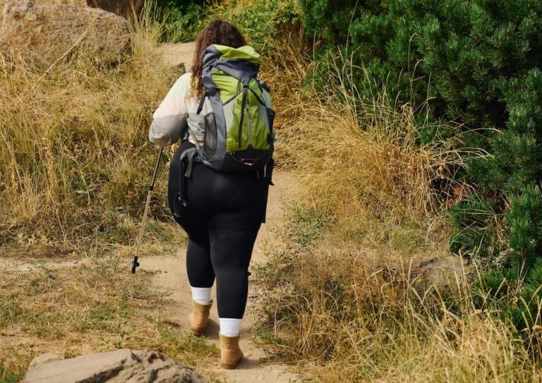 A woman hiking in the mountains, symbolizing the journey of trauma recovery with EMDR therapy.