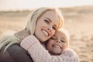 The image shows a happy mother with her child after parts work therapy.