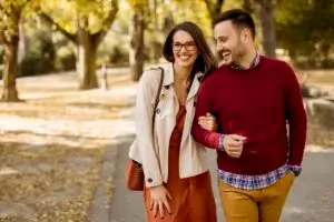 An empowered couple in the park after a therapy session, knowing what happens in trauma counselling.