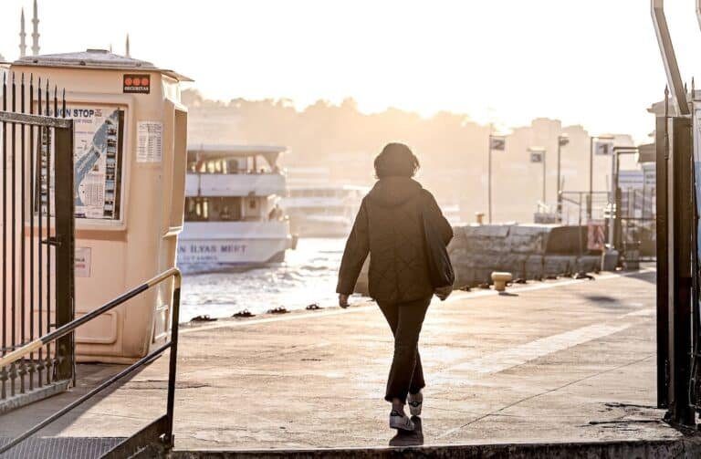 A woman going through a gate in sunlight, symbolizing the change when knowing how to heal from childhood abuse.