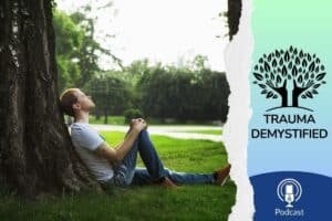 A man leans quietly against a tree, eyes closed, grounded in stillness. The gentle light filtering through the leaves evokes a sense of calm and reflection. This image captures the essence of the podcast episode “How to Create Safety After Childhood Trauma”—a journey of returning to inner calm, reconnecting with the body, and discovering what safety can feel like after trauma. Just as the tree offers steady support, healing asks us to root ourselves in care, presence, and patience.