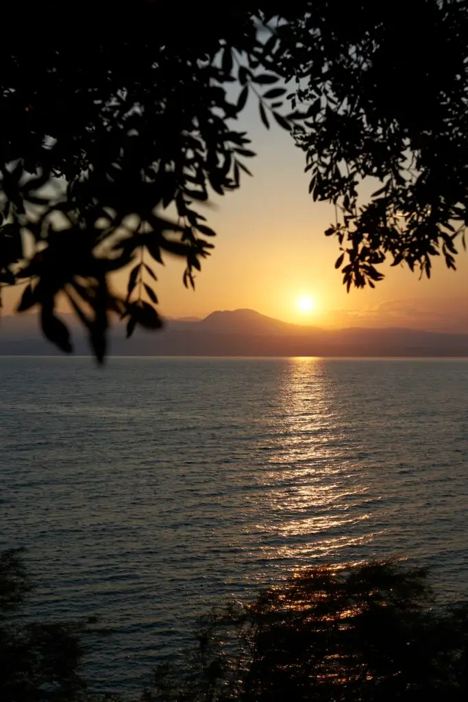 Sunrise over a lake symbolizing overcoming adversity with trauma-informed grief counselling in Calgary.