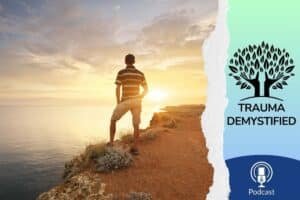 Person standing on a mountaintop at sunset, overlooking a calm sea — symbolizing the strength, clarity, and inner peace found in healing relational trauma.
