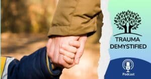 Two people wearing winter coats gently holding hands outdoors, symbolizing warmth, safety, and healing from childhood trauma triggers in adulthood.