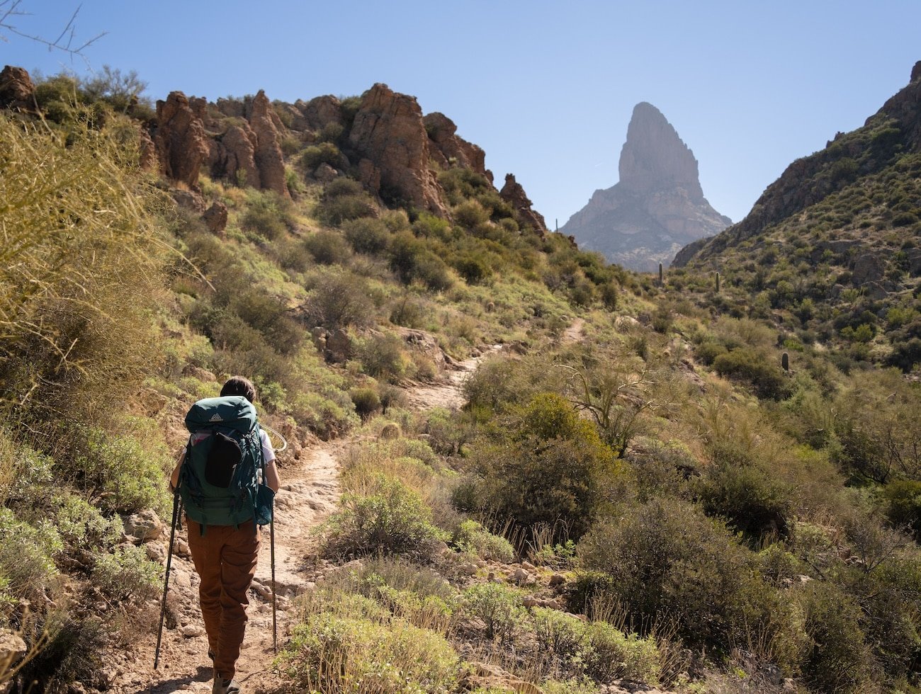 Person hiking on a stoney path in the mountains, symbolizing the recovery journey with complex trauma counselling.